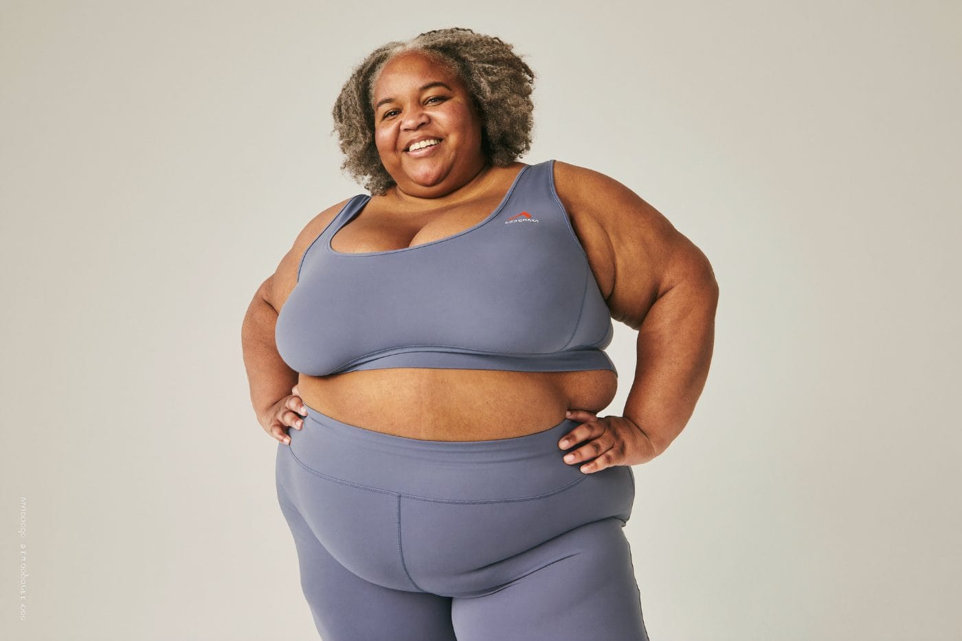 A confident woman with hands on her hips
